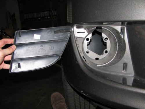 Stock fascia blank removed, right side.  There are  four hooks (one at each corner) that hold it in.  After trying to be careful removing the right side, I said to hell with it and cut the tabs on the left side and threw away the blanks.
