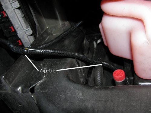 Where I zip-tied the left side of the harness.  It comes down near the radiator over-flow container (the pink bottle).  Don't use the aluminum object to the left, that's the heat-sink for the coils!
