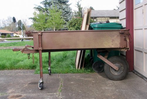 Here I removed the upper wood box.  I took two of the C-channel side braces that were used to hold the wood panels and with a little drilling, cutting, welding, and two polyurethane castor wheels, made them into removable legs that can be used to support and move the trailer for the time being.
