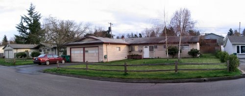 Panoramic view of property front.  Shed will be in backyard on right side of image.
