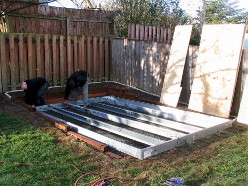 The builders setting up the galvanized floor framing.  I messed up :-(  The site wasn't exactly square and I should've expanded the width an additional 3" for a total of 6" per side, left and right, to give a little more spacing between the shed and site walls.  But the guys said it's no big deal and, overall, I did a really good job.
