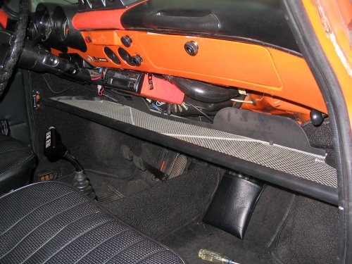 Installed and what it is.  Simply a tray that installs under the dash.  My particular model uses a synthetic webbing inside the frame.  Rubber trim surrounds the metal frame on the front and sides while the back is black metal trim.
