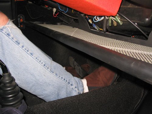 My seat is all the way back and I have about six inches of space between my shin and the back of the parcel tray.
