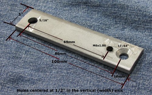 Added:  Everything you need to know to mount a MOSFET R/R!
Here's the bracket I made from some scrap steel I had.  It's 3/16" (5mm) thick.  If you use a different thickness just make sure the piece used is thick enough to hold 4 threads at a MINIMUM!  You want plenty of fastener thread engagement for the M6x1.00mm tap as that is where one side of the MOSFET R/R will be mounted.  The chamfered hole is made with a 17/64" bit and then widened via chamfering.  NOTE:  Prior to this I had my MOSFET R/R mounted in the stock location with just one bolt and had NO ISSUES with it coming loose/moving.
