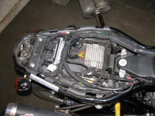 Here's what you'll see when you remove the seat.  Everything is in the stock location and nicely packaged.  The stock location does allow air flow but it's not the greatest.

For clarification, I refer to the regulator/rectifier as "R/R" to keep things short-n-sweet.
