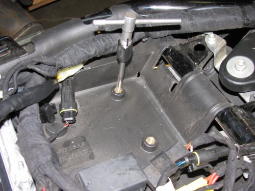 Next, use a 6mm x 1.00 tap to thread the brass and plastic that you drilled through.
