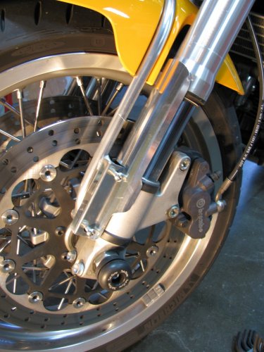 Put the guard in position, put a drop of blue Lok-tite on the bolts, and tighten them up to the point of barely touching the protector.
