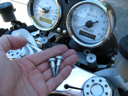 Remove the stock bolts using a 5mm Allen wrench.  Keep the stock bolts because you use them to remount the gauges to the lowering brackets.

