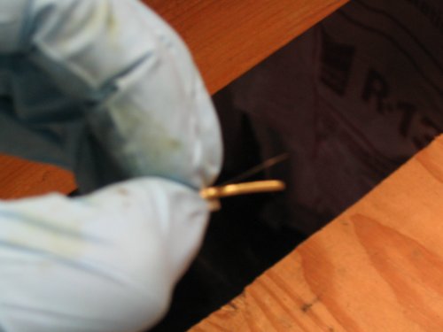 Bad picture of how the flap stop goes back in.  Pieces curve away from each other.
