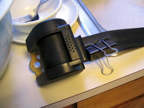 Take your 'new' belts and clean them.  Do this by pulling out the belt and securing it with something to keep it from retracting.
