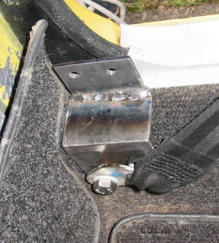 Here's the lower outside mount and new bracket, mounted to the old stock location.  This is shown for illustration purposes -- you need to mount the retractor first, then the bracket to the body.
