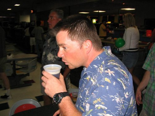 At the bowling alley Scott starts the games with a brew.
