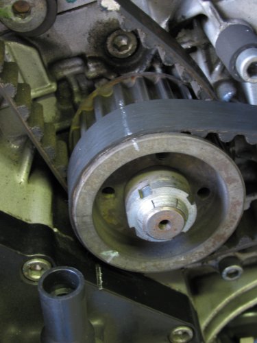 Line up the pulley markings with those on the engine case.  I used a white grease pencil (china marker) to mark the points on both the case and pulleys for faster visual confirmation.  You can see here I drew a line all of the way across the horizontal belt and center pulley as a precaution.  I marked the replacement (new) horizontal belt the same way as the vertical belt explained here.
