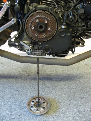 Unscrew the bolts and remove the spring caps and springs.  The pressure plate then pulls straight out and the push rod comes with it.
