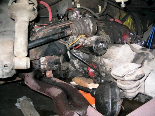 Engine lowered and pulled back a little so left axle can be maneuvered to the top of the starter.
