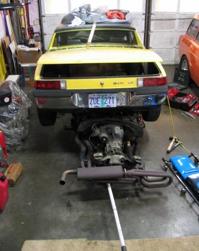 Drive train balanced on the floor jack and on its way out.
