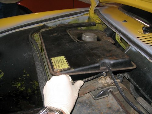 Remove the other 10mm bolt from the left side of the expansion tank. 
