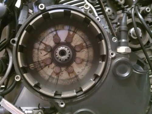 Here's how the clutch basket looked.  Those streaks are LOTS of thread locker applied at the factory.  It leaked out the back side as well.  After removing the eight retaining bolts I had to use a drift and tap a couple of the ears on the basket to gently break it free.
