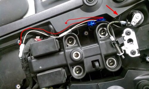 The pigtail length I used was 35mm and the red line shows how it's laid inside the seat pan with the resistor wires coming in an OEM hole (arrow) and spliced into it.  This is all hidden by the "tool tray".  I could've shortened it by a couple centimeters but it works as is.
