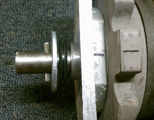 Reference:  Rear gear box, rear side.
Rear side of rear gear box.  Steel roll pin is 3/16" diameter by 1-1/2" long.  This is where the crank handle connects.  The zinc washer is 2" diameter with a 3/4" hole and is a tad thicker than the original one (I couldn't find a thin one).  The grommet between the washer and case is 1-5/8" outside diameter (OD) and 1/4" thick so it's just slightly thinner than the original one.

