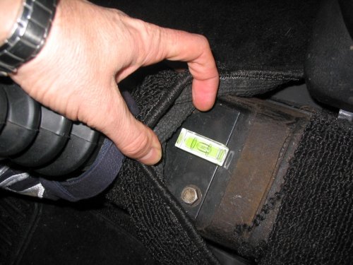 Spirit-level on the shift plate on the shift tunnel to show how much my car is raked.  As you can see, it's very mild so the engine is pretty close to the same level as the pan.
